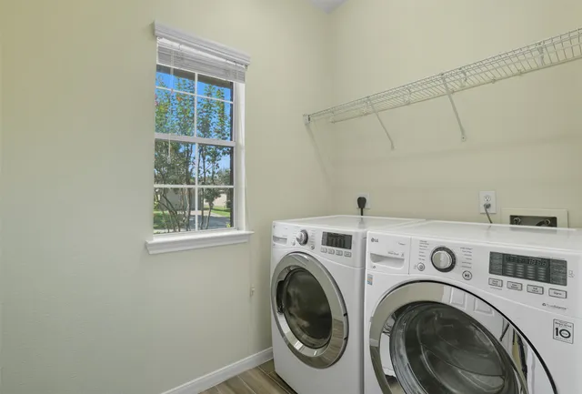 a view of storage and utility room with washer and dryer