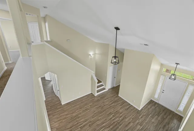 a view of an entryway with wooden floor