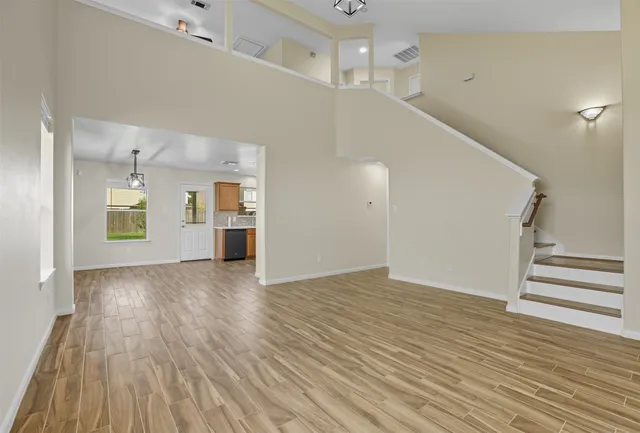 wooden floor in an empty room with a window