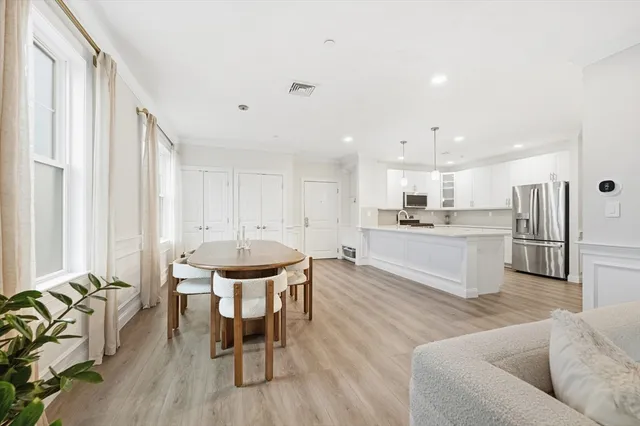 a living room with furniture and kitchen view