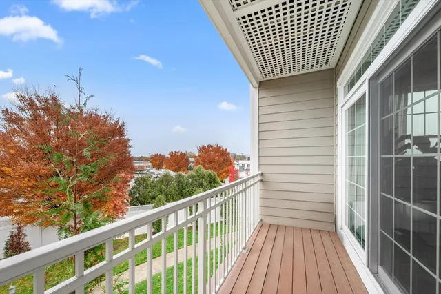 a balcony with wooden floor and fence