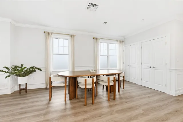 a view of a dining room with furniture and wooden floor