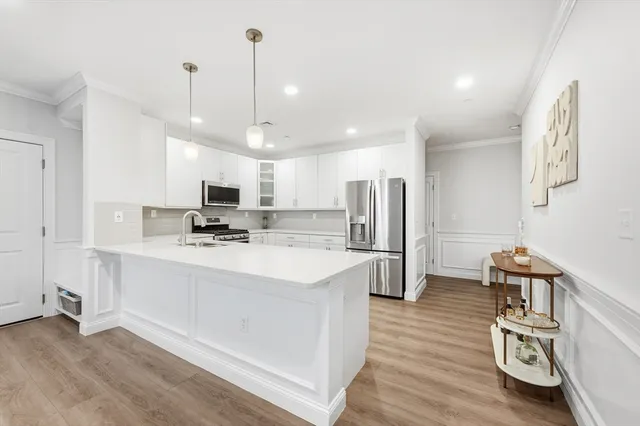 a kitchen with stainless steel appliances kitchen island a refrigerator and a stove