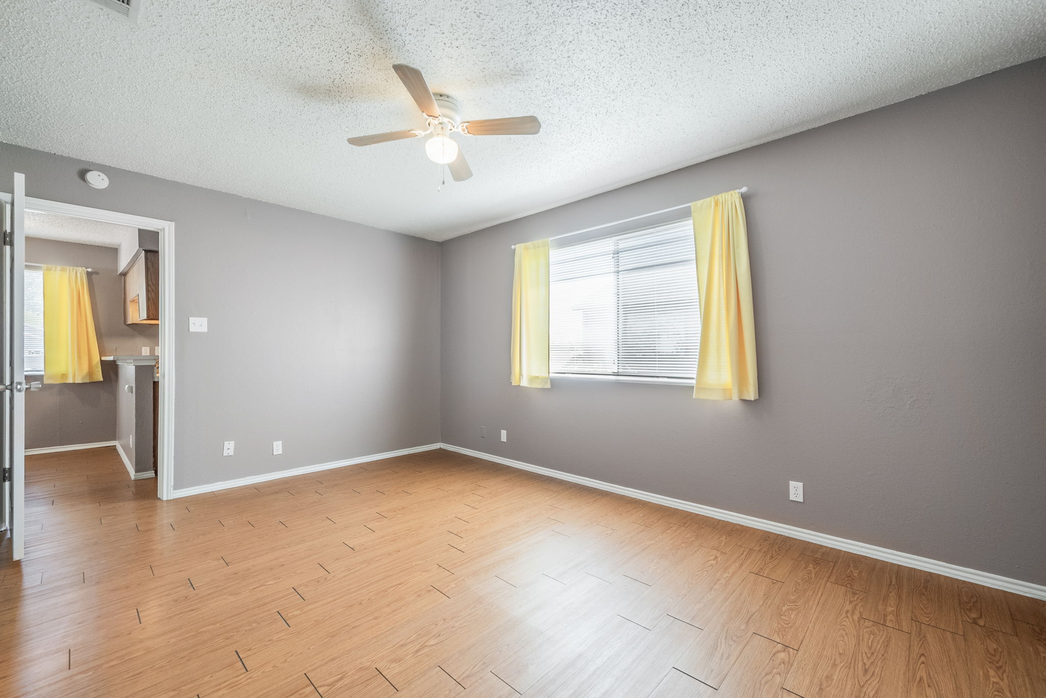 5807 Spring Meadow Road, Unit B Austin, TX 78744 - Photo 20 of 31 Well-lit living area featuring engineered wood flooring and a refreshing ceiling fan for comfort.