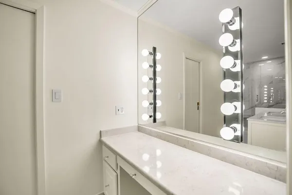 a bathroom with a granite countertop sink and a mirror