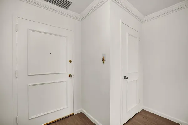 a view of a hallway with wooden floor
