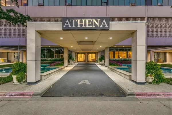 a view of a building with a park on the road