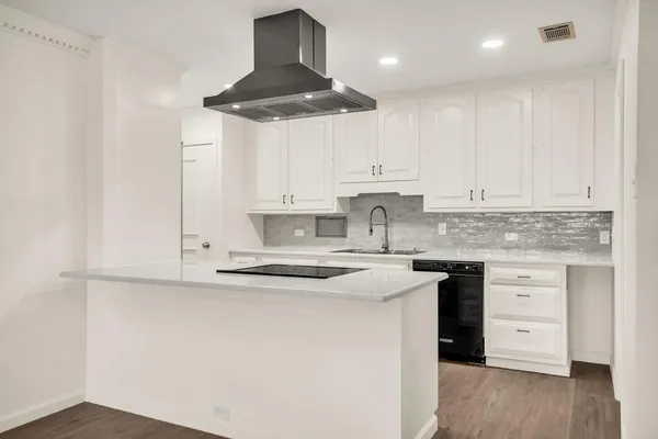 a kitchen with stainless steel appliances granite countertop a sink and cabinets
