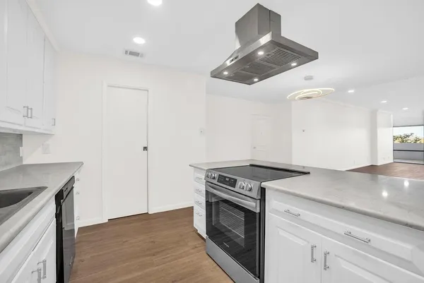 a kitchen with a stove and a sink