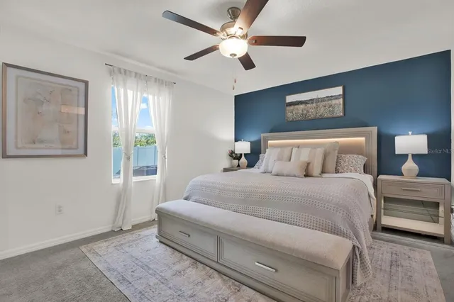 a spacious bedroom with a bed and a painting on the wall