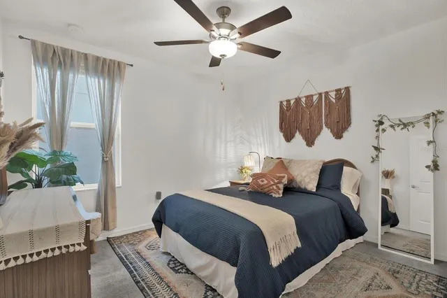 a bedroom with bed and a window