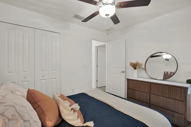 a bedroom with a bed and a chandelier