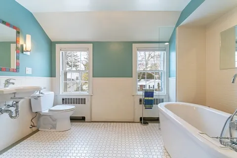 a bathroom with a bathtub and window