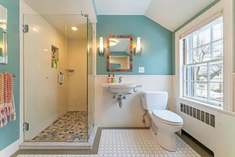 a bathroom with a sink toilet and shower
