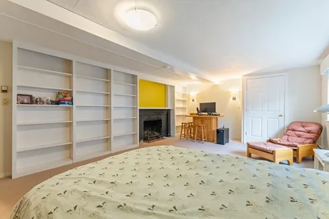 a bedroom with furniture and a fireplace