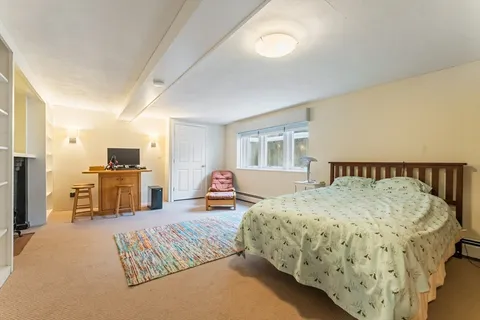 a bedroom with bed and large mirror