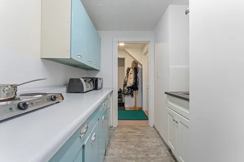 a kitchen with a refrigerator and a sink