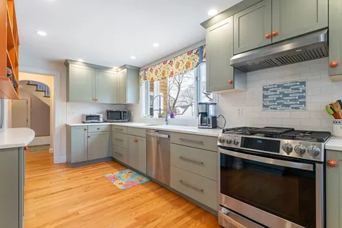 a kitchen with a stove a sink and a microwave