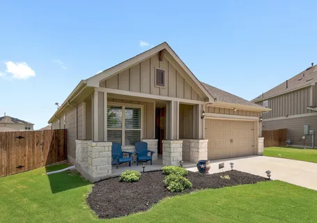 a front view of house with a garden and patio