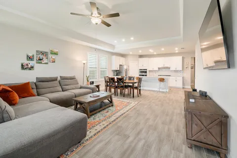 a living room with furniture and kitchen view