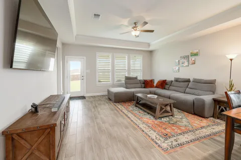 a living room with furniture and a chandelier