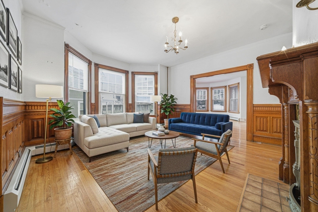 a living room with fireplace furniture and a floor to ceiling window