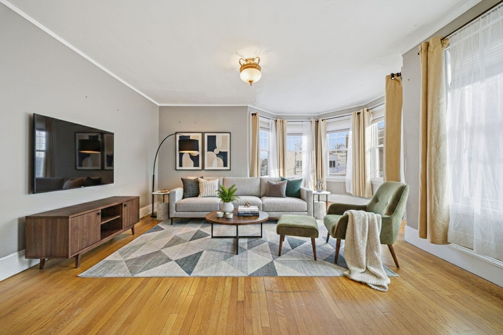 87 Burt Street Boston, MA 02124 - Photo 19 of 40 a living room with fireplace furniture and a flat screen tv