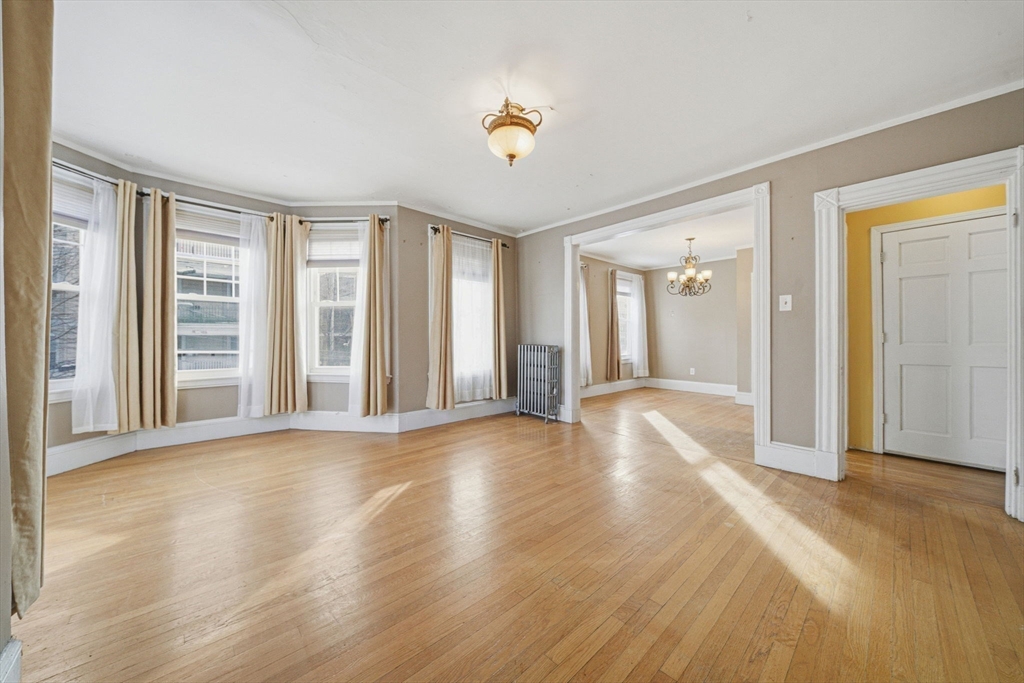 87 Burt Street Boston, MA 02124 - Photo 20 of 40 a view of a livingroom with wooden floor and window