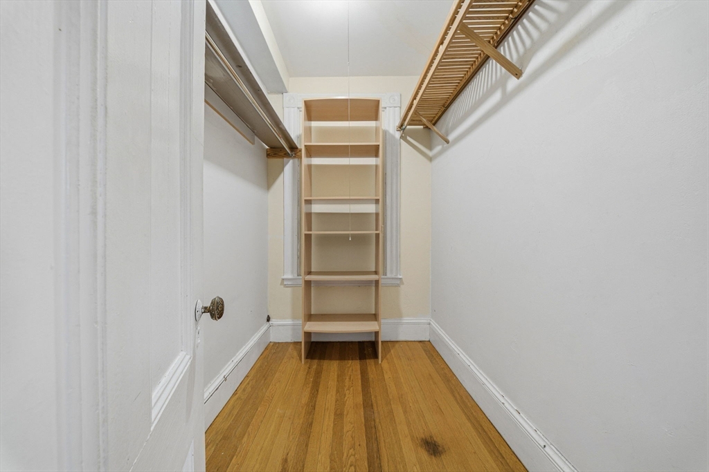 87 Burt Street Boston, MA 02124 - Photo 27 of 40 a view of walk in closet with empty racks