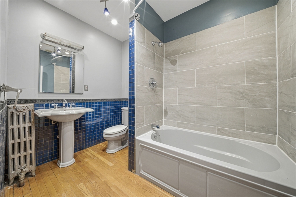 87 Burt Street Boston, MA 02124 - Photo 28 of 40 a bathroom with a granite countertop sink a toilet and bathtub