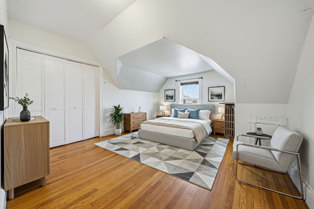 87 Burt Street Boston, MA 02124 - Photo 32 of 40 a bedroom with a large bed and a couch