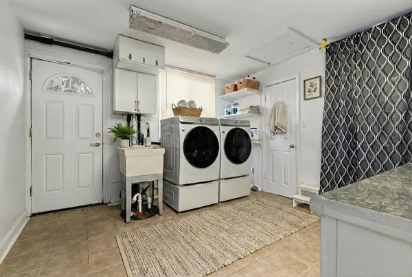 a kitchen with a refrigerator and white cabinets