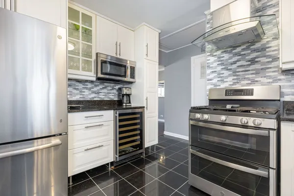 a kitchen with appliances and cabinets