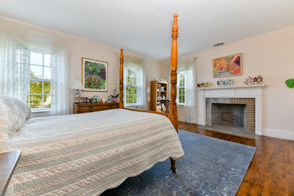 337 Buckminster Road Brookline, MA 02445 - Photo 17 of 22 a spacious bedroom with a bed and a fireplace