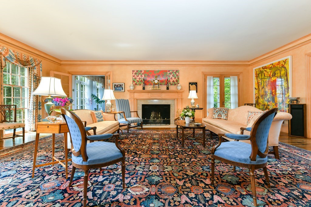 337 Buckminster Road Brookline, MA 02445 - Photo 4 of 22 a living room with furniture a fireplace and a floor to ceiling window