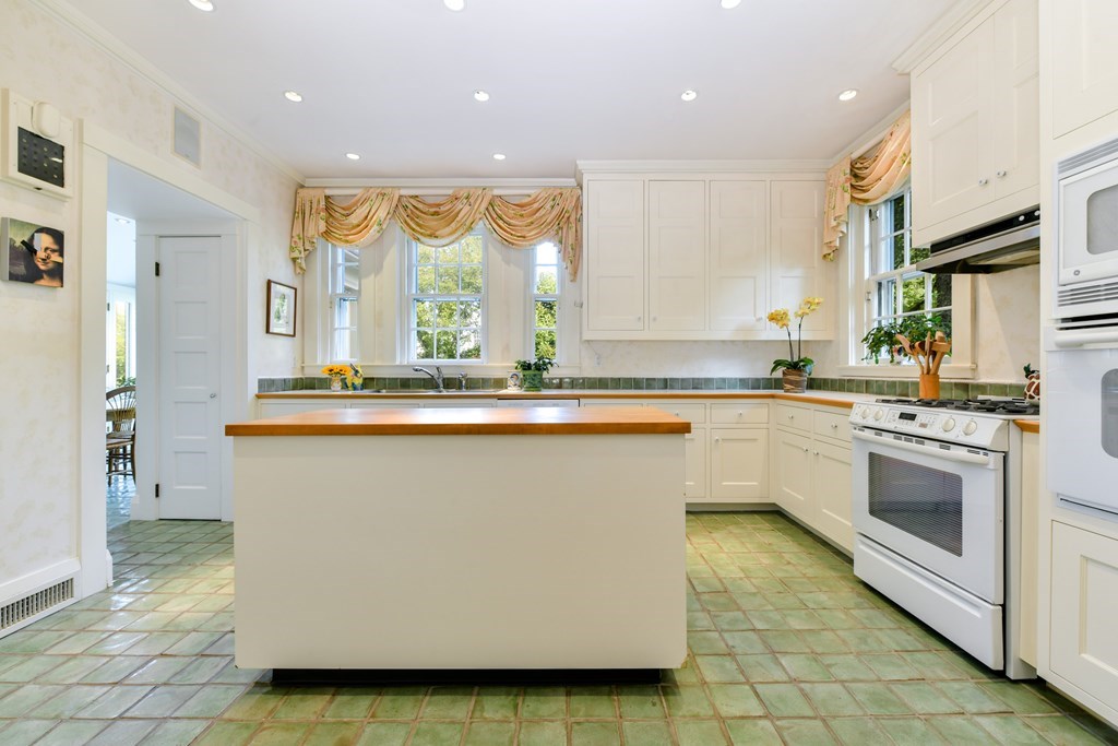 337 Buckminster Road Brookline, MA 02445 - Photo 10 of 22 a large kitchen with stainless steel appliances granite countertop a stove a sink and a microwave