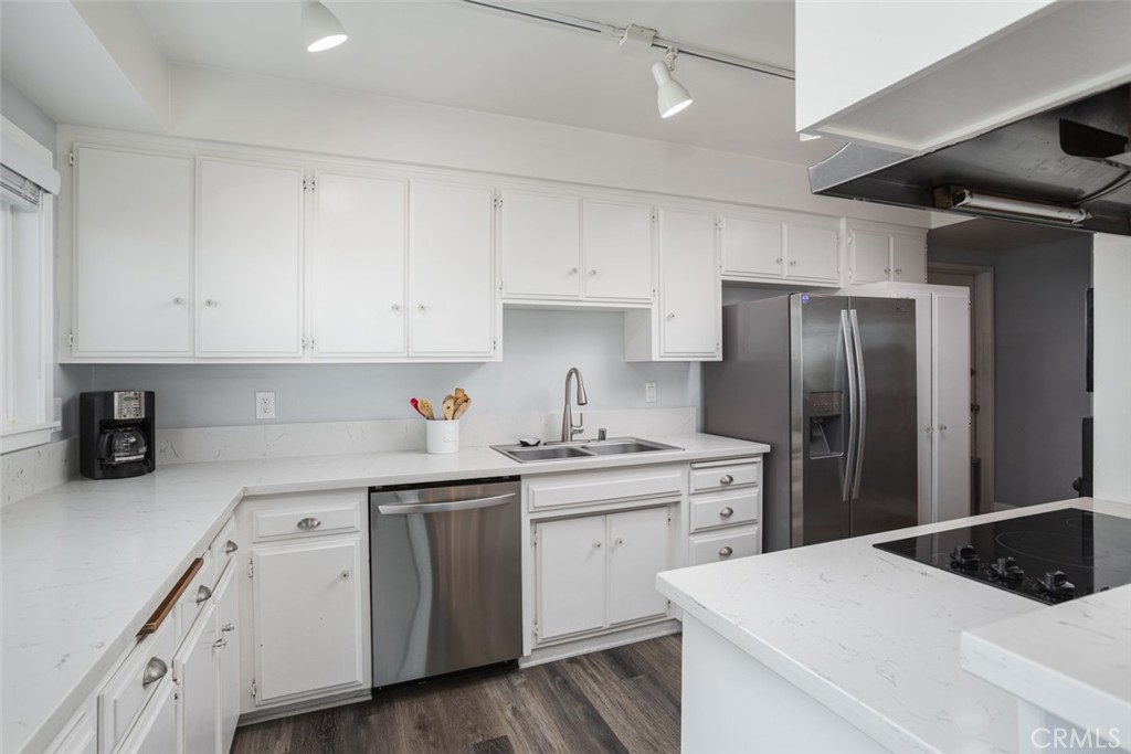 200 East Oceanfront Newport Beach, CA 92661 - Photo 13 of 36 a kitchen with a sink white cabinets and stainless steel appliances