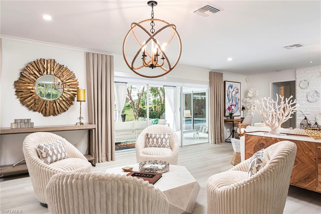 2728 Crayton Road Naples, FL 34103 - Photo 3 of 14 a bedroom with furniture and a large window