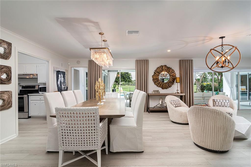 2728 Crayton Road Naples, FL 34103 - Photo 4 of 14 a view of a dining room with furniture window and wooden floor