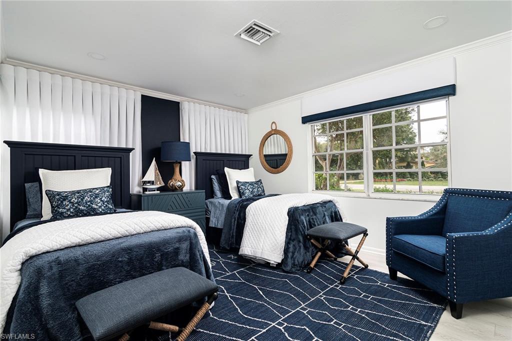 2728 Crayton Road Naples, FL 34103 - Photo 8 of 14 a bedroom with two beds and a large window