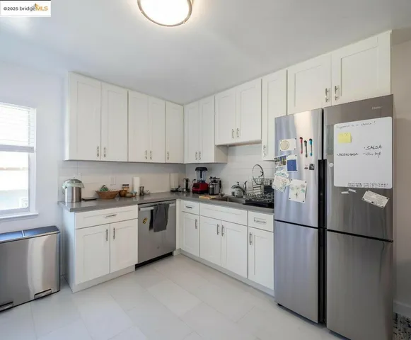 a kitchen with stainless steel appliances granite countertop white refrigerator stove a sink and dishwasher
