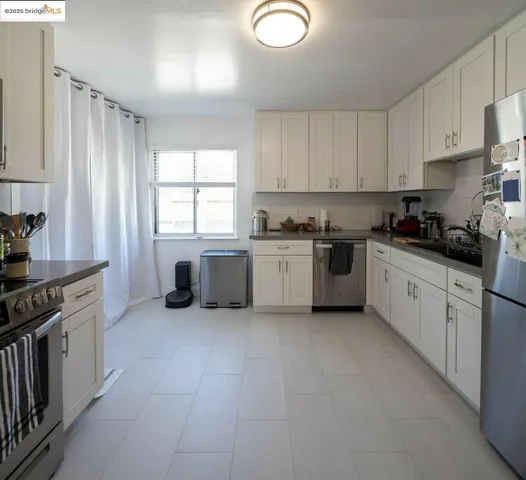 a kitchen with stainless steel appliances a sink stove and cabinets