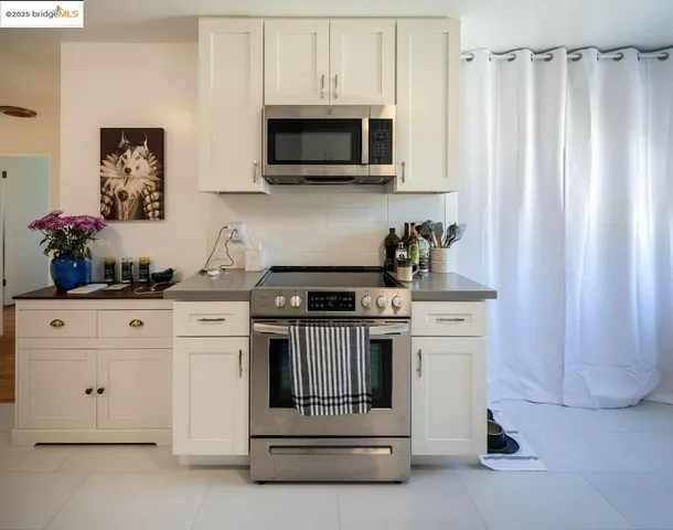 a kitchen with stainless steel appliances white cabinets and a stove