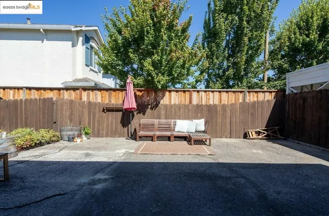 an outdoor space with patio furniture and potted plants
