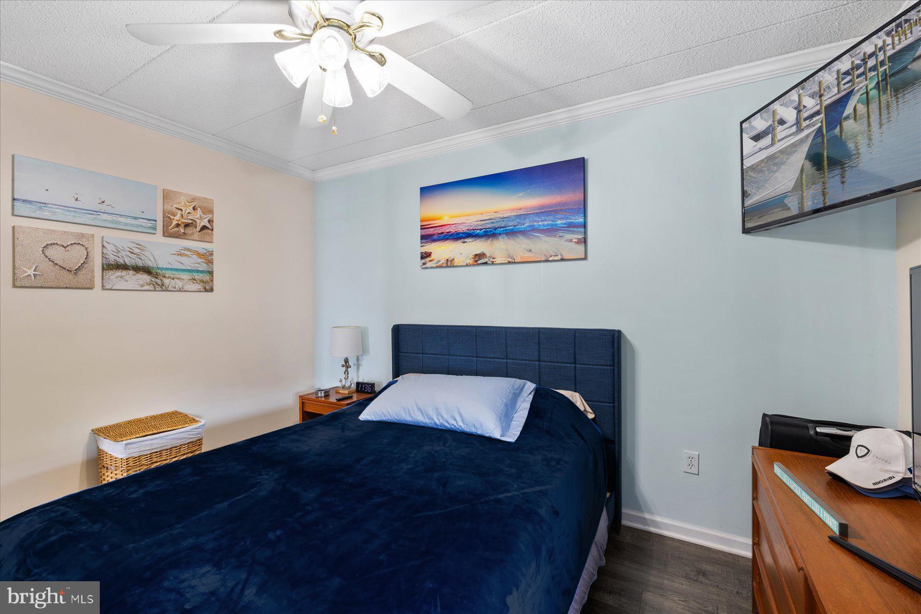 14 38th Street, Unit 301 Ocean City, MD 21842 - Photo 11 of 20 a bedroom with a bed and wooden floor