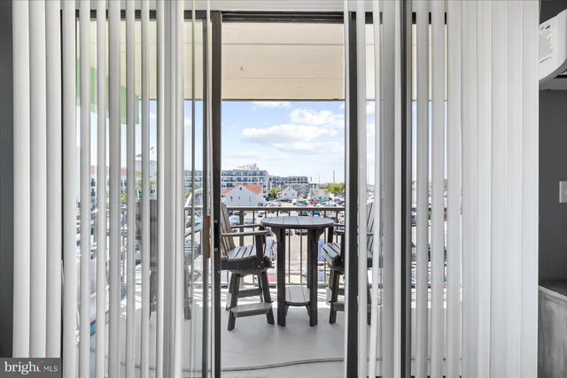 a view of a balcony with furniture and floor to ceiling window
