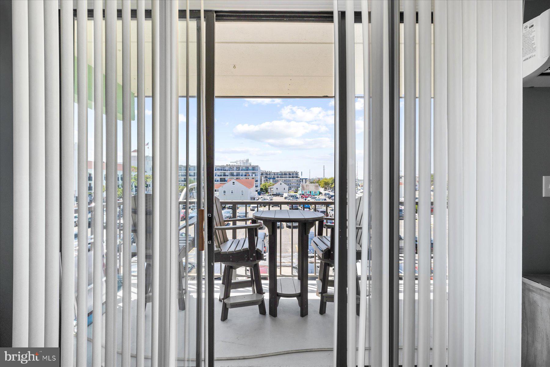 14 38th Street, Unit 301 Ocean City, MD 21842 - Photo 15 of 20 a view of a balcony with furniture and floor to ceiling window