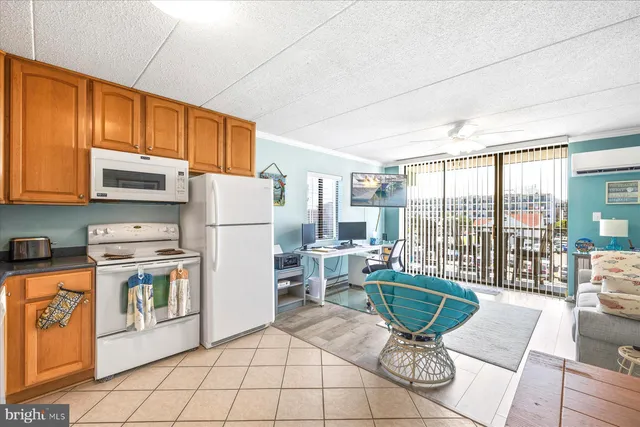 a kitchen with a refrigerator a stove a dining table and chairs