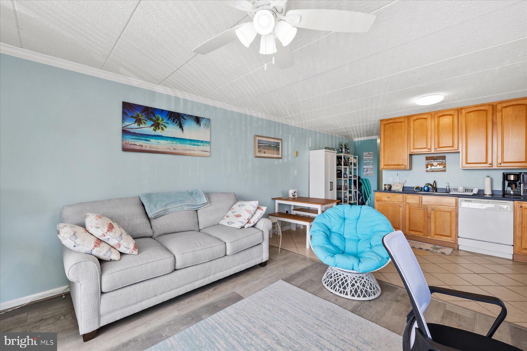 14 38th Street, Unit 301 Ocean City, MD 21842 - Photo 6 of 20 a living room with furniture a large window and a kitchen view