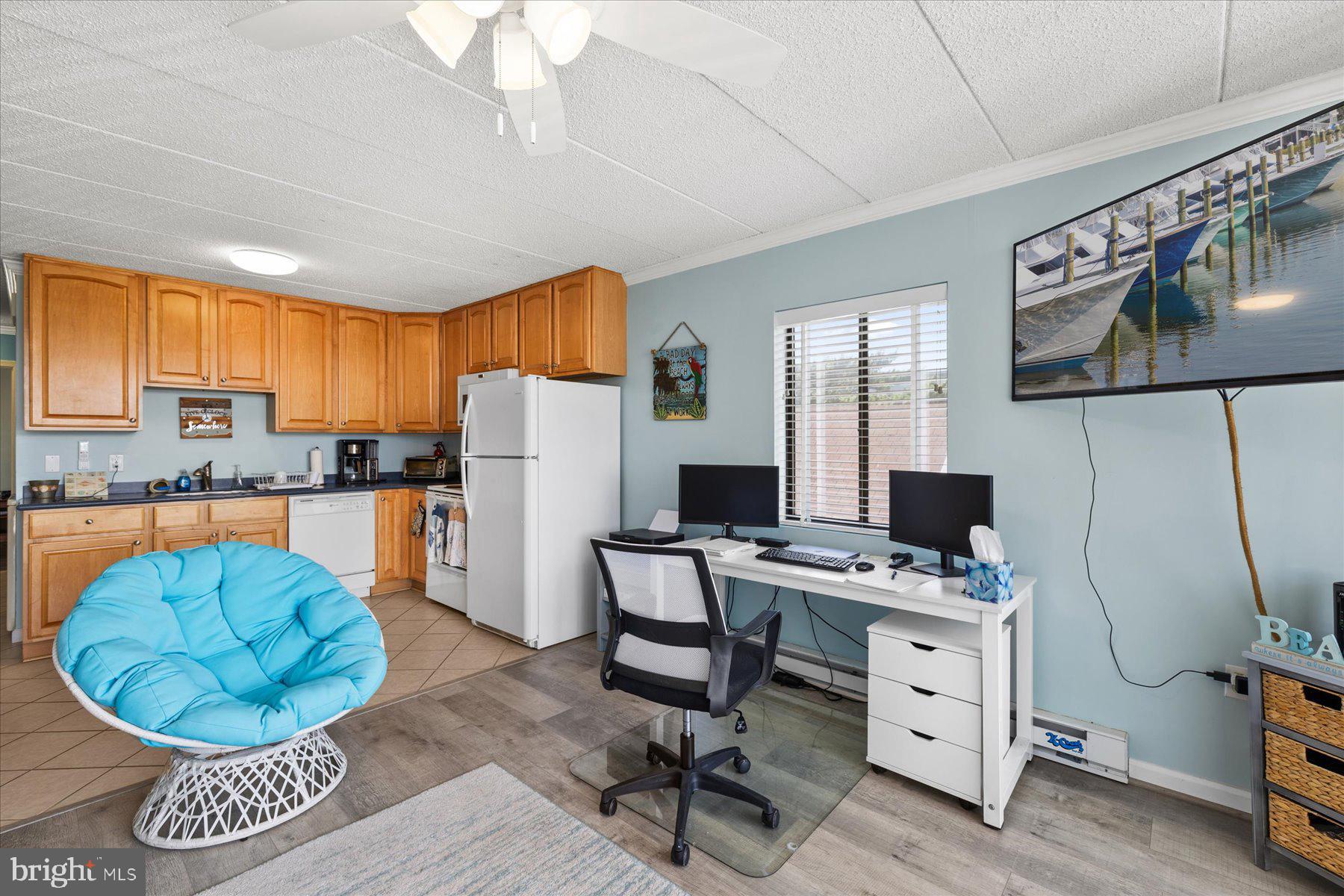 14 38th Street, Unit 301 Ocean City, MD 21842 - Photo 7 of 20 a kitchen with stainless steel appliances a stove a refrigerator cabinets and a dining table